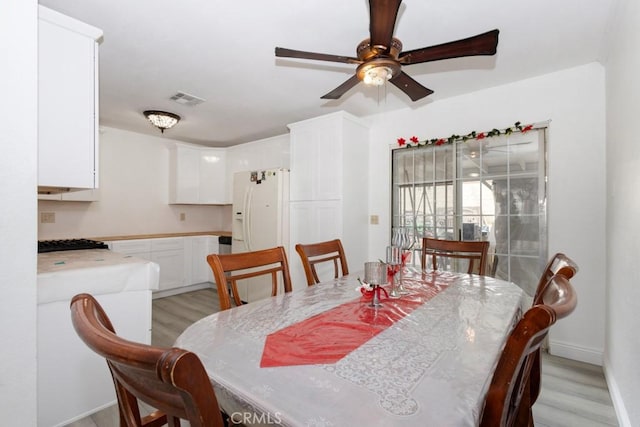 dining room featuring light hardwood / wood-style floors and ceiling fan