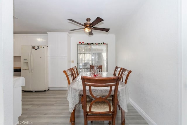 dining room featuring light hardwood / wood-style floors and ceiling fan