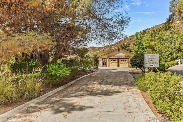 view of front facade with a mountain view and a garage