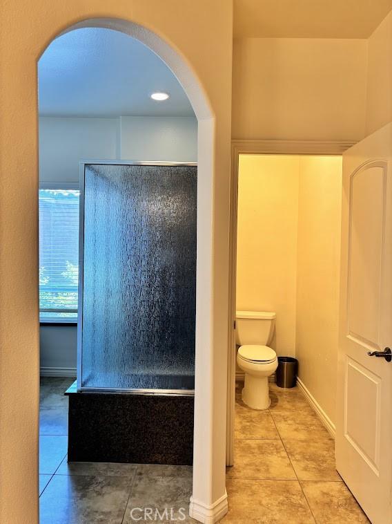 bathroom featuring tile patterned floors and toilet