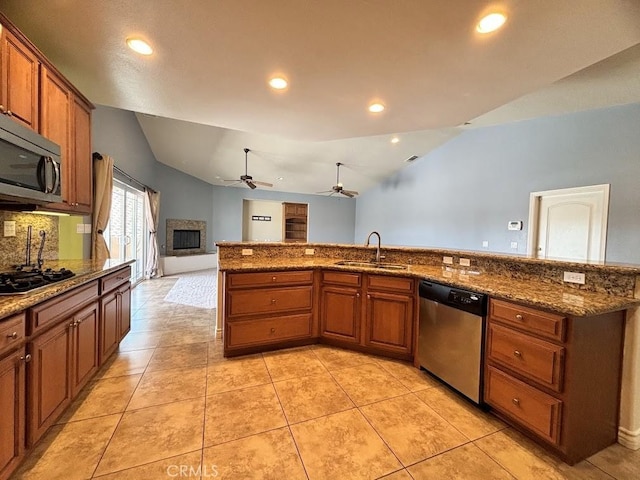 kitchen featuring appliances with stainless steel finishes, ceiling fan, sink, light tile patterned floors, and lofted ceiling