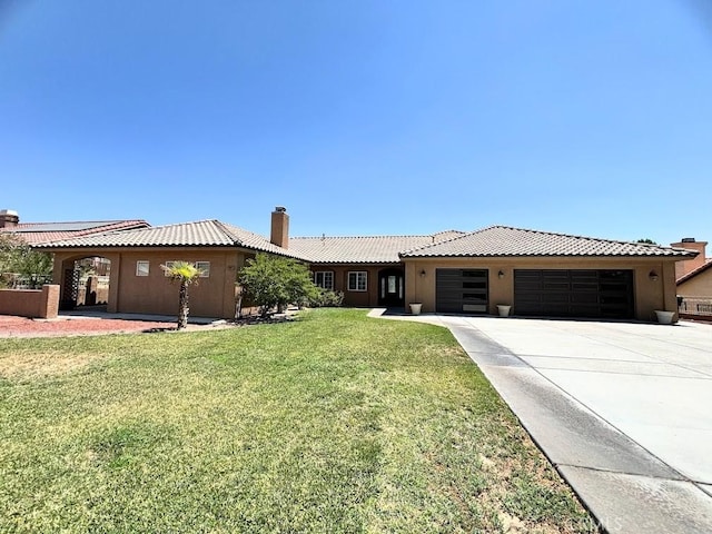 single story home with a front yard and a garage