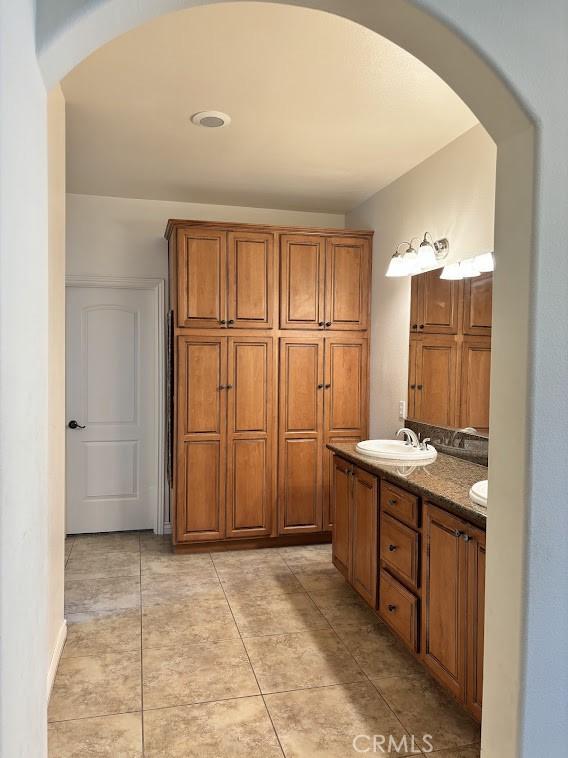 bathroom featuring tile patterned flooring and vanity