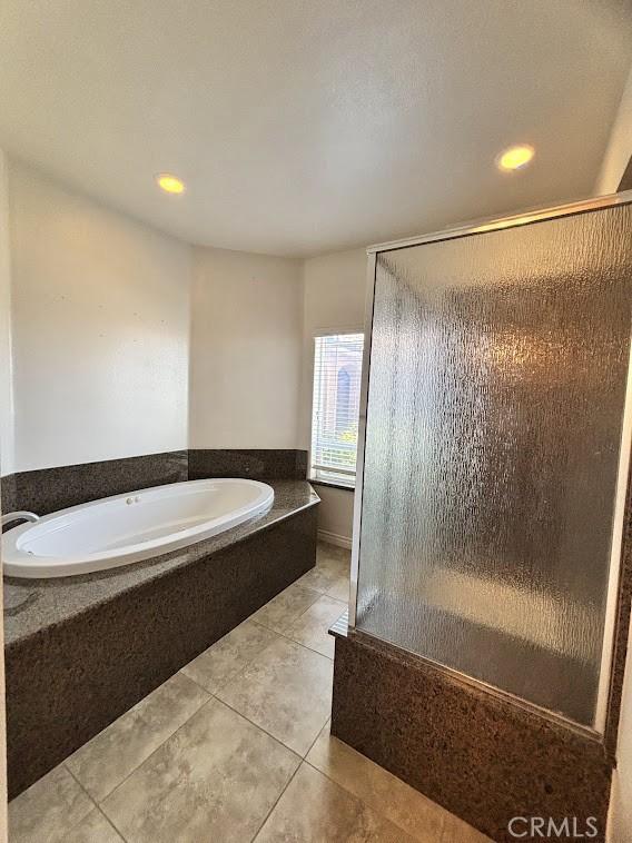 bathroom featuring tile patterned flooring and a tub