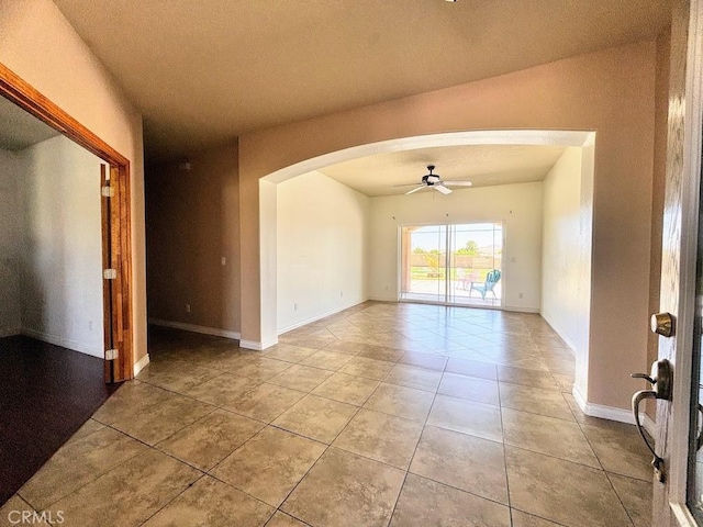 unfurnished room with ceiling fan, light tile patterned flooring, and a textured ceiling