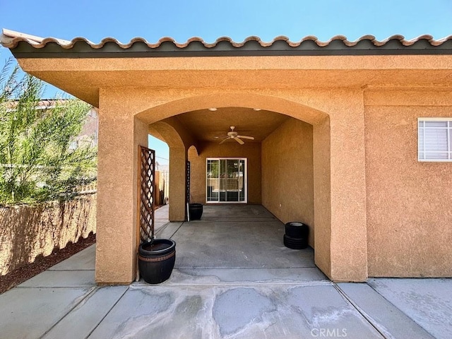 property entrance with ceiling fan and a patio area