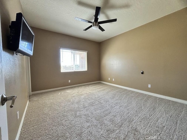 empty room with a textured ceiling, carpet floors, and ceiling fan