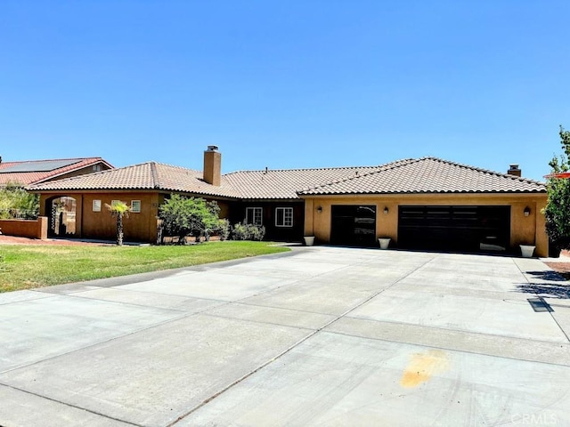 view of front facade with a front lawn and a garage