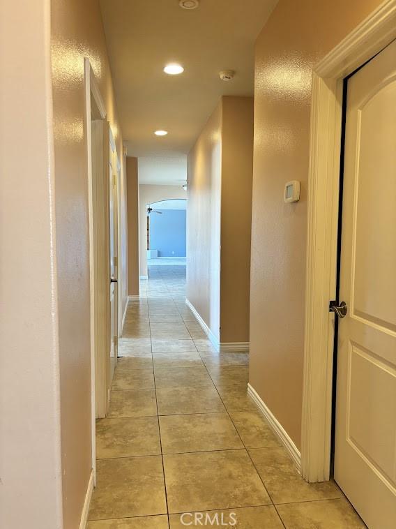 hall featuring light tile patterned floors