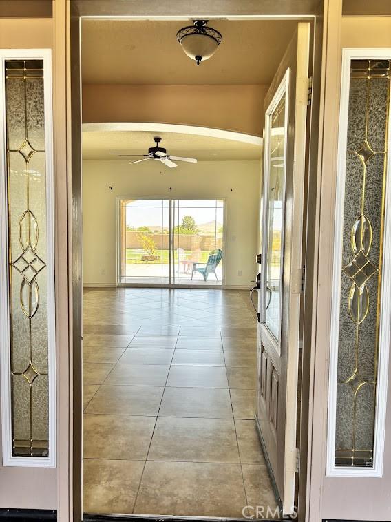 hall featuring light tile patterned floors