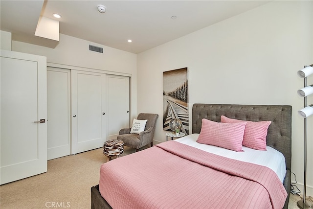 bedroom with light carpet and a closet