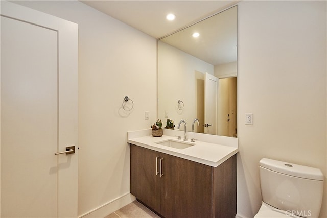 bathroom featuring vanity, toilet, and tile patterned floors