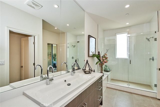 bathroom featuring tile patterned floors, walk in shower, and vanity