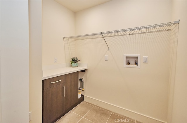 laundry room featuring washer hookup and light tile patterned floors