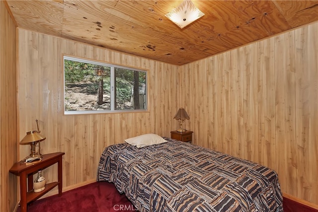 bedroom with wood ceiling, wood walls, and carpet floors