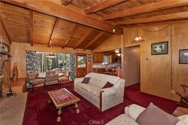 carpeted living room with vaulted ceiling with beams, wooden walls, and wooden ceiling