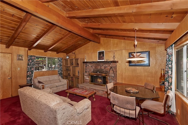 living room featuring vaulted ceiling with beams, wood ceiling, a brick fireplace, wooden walls, and dark colored carpet