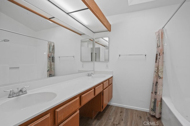 bathroom featuring vanity, hardwood / wood-style flooring, and shower / bath combo