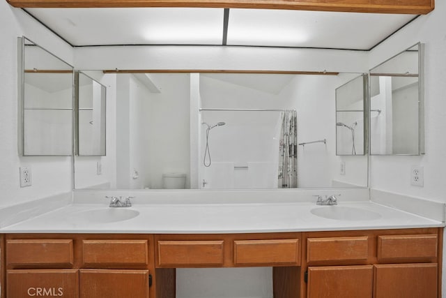 bathroom with walk in shower, vanity, lofted ceiling, and toilet