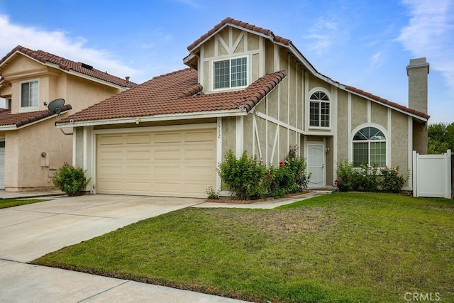 view of front of house with a front yard and a garage