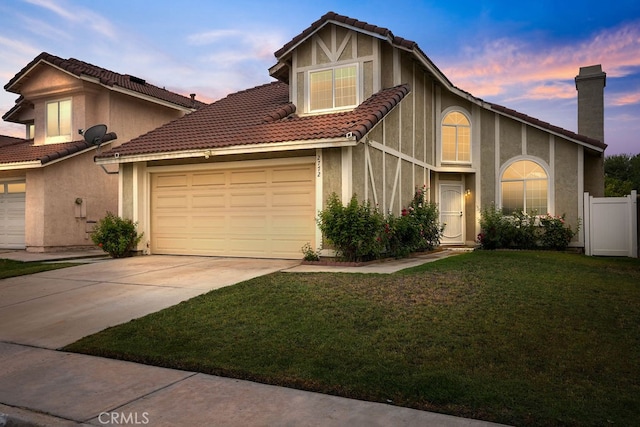 view of front of home featuring a yard and a garage