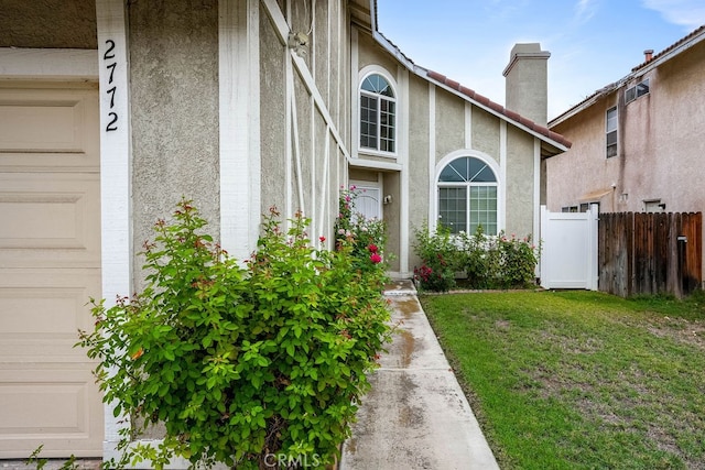 entrance to property with a lawn and a garage