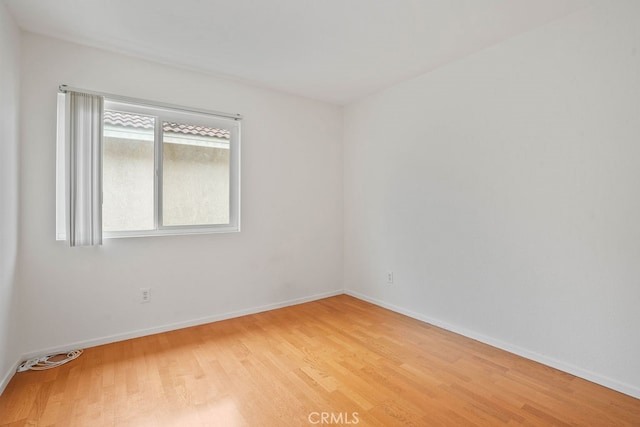 spare room with light hardwood / wood-style flooring