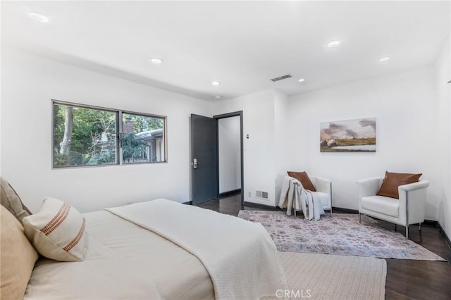 bedroom with dark hardwood / wood-style flooring