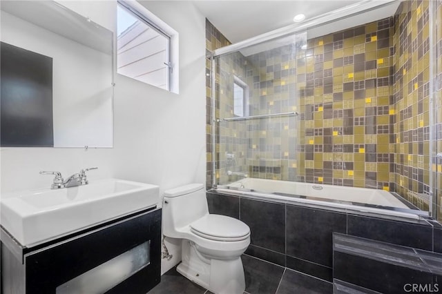 full bathroom featuring bath / shower combo with glass door, vanity, and toilet