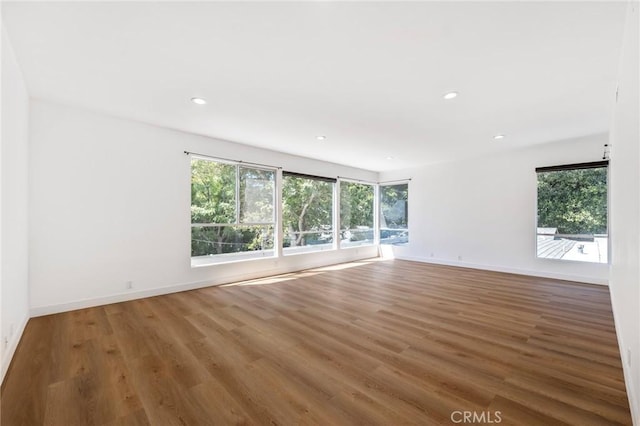 unfurnished room with hardwood / wood-style floors