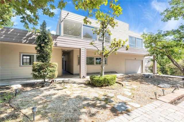 view of front of home featuring a garage and a patio