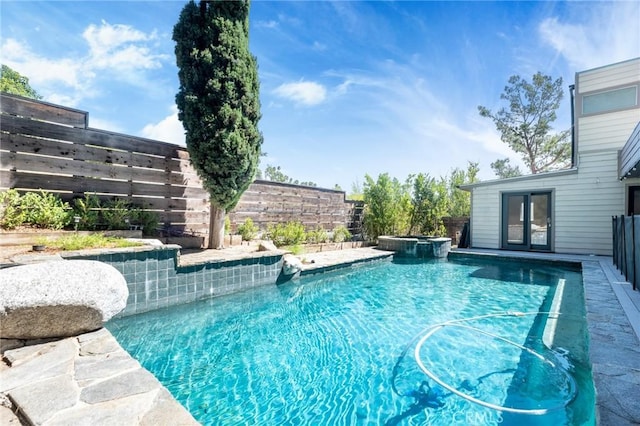 view of pool with an in ground hot tub