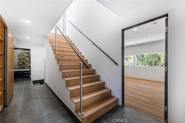 stairs featuring tile patterned floors