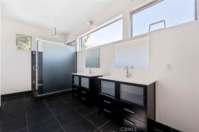 bathroom featuring vanity, tile patterned floors, and walk in shower