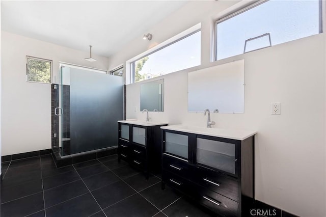 bathroom with tile patterned floors, an enclosed shower, and vanity