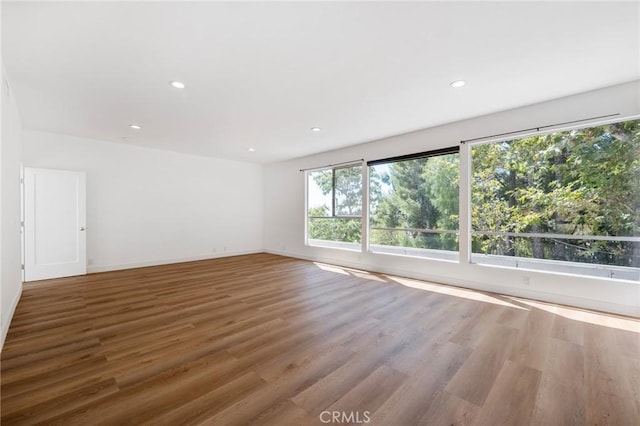 unfurnished room with hardwood / wood-style floors