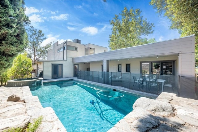 view of swimming pool with an in ground hot tub and a patio