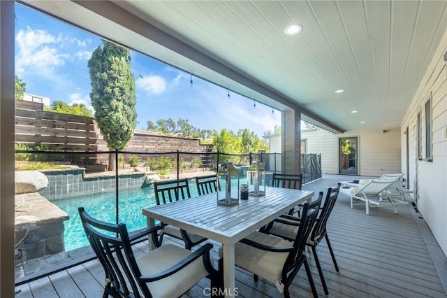 wooden deck featuring a fenced in pool