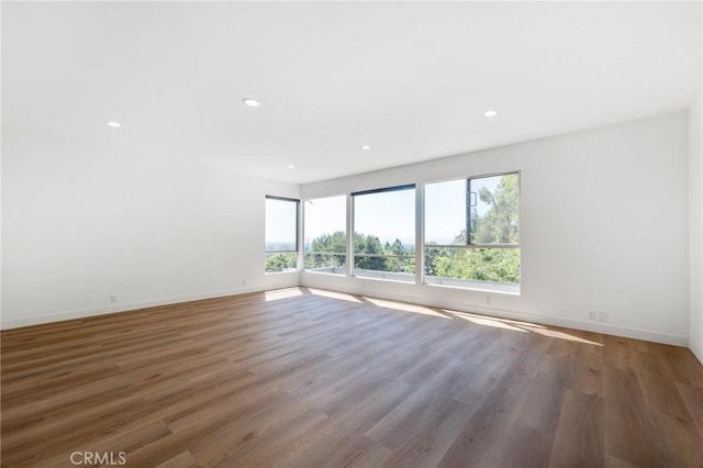 empty room with dark hardwood / wood-style flooring