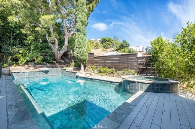 view of swimming pool with an in ground hot tub