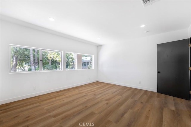 unfurnished room with hardwood / wood-style floors