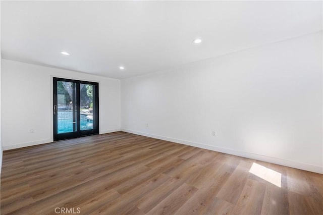 empty room with hardwood / wood-style floors