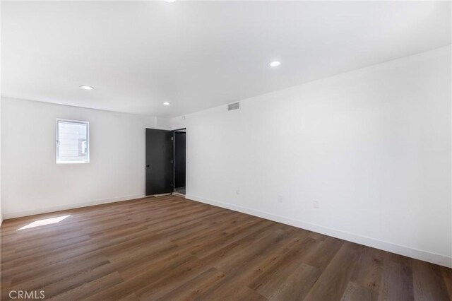 spare room featuring dark hardwood / wood-style floors