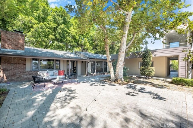 view of front of house featuring outdoor lounge area and a patio area