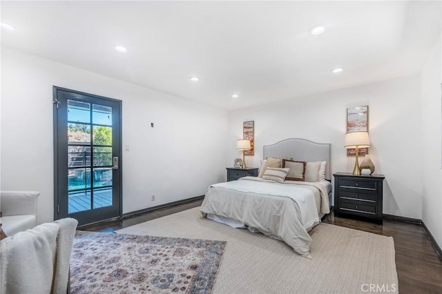 bedroom featuring dark hardwood / wood-style flooring and access to exterior