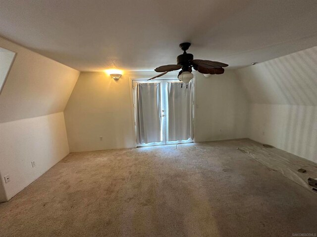 additional living space featuring ceiling fan, carpet, and vaulted ceiling