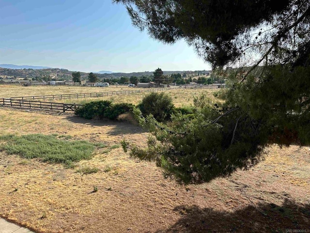 view of yard featuring a mountain view and a rural view