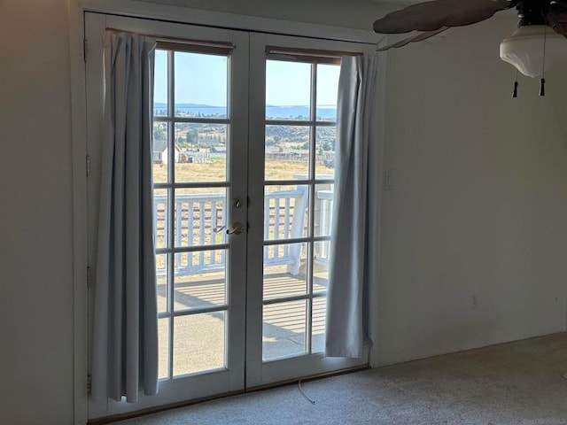 doorway to outside with french doors, carpet floors, and ceiling fan