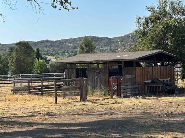 view of stable featuring a mountain view