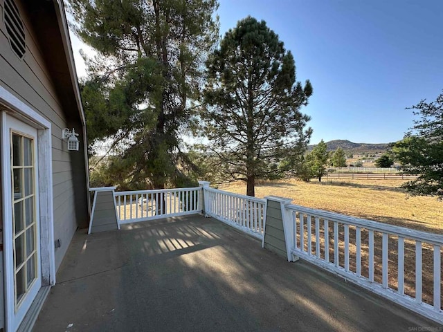 wooden deck featuring a mountain view and a rural view